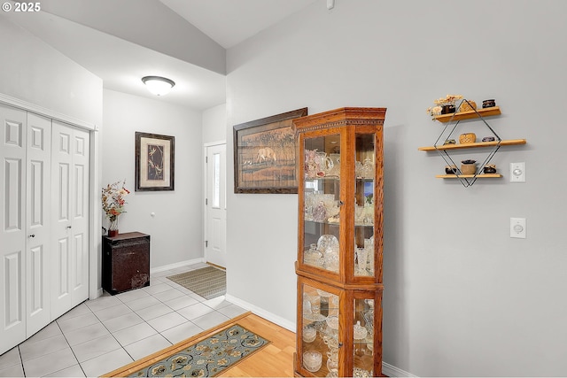 entrance foyer featuring baseboards and light tile patterned floors