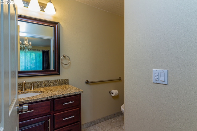 30258 King Ln, Hermiston, OR 97838 - bathroom with vanity, toilet, and tile patterned floors