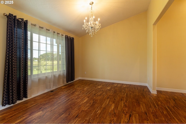 30258 King Ln, Hermiston, OR 97838 - spare room with dark wood-style flooring, a chandelier, baseboards, and lofted ceiling