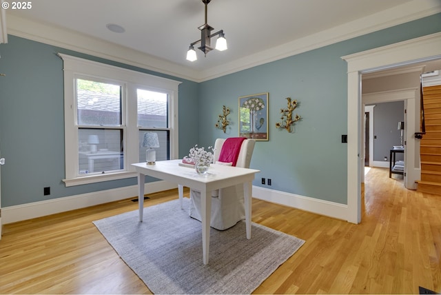 home office featuring light wood-style floors, baseboards, and crown molding