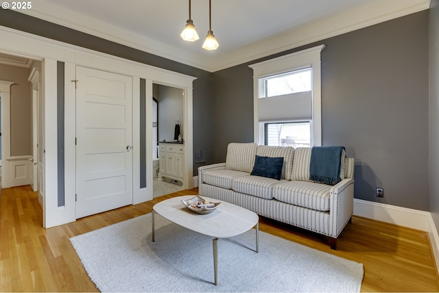 living room with light wood finished floors and ornamental molding