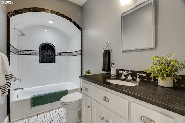 full bath featuring toilet, vanity, and bathing tub / shower combination