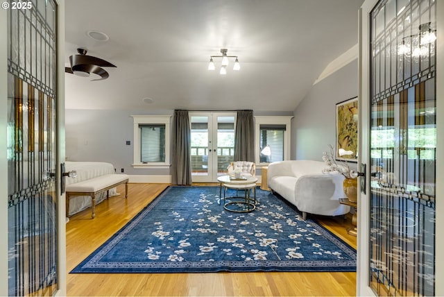 living room with french doors, wood finished floors, vaulted ceiling, and ceiling fan