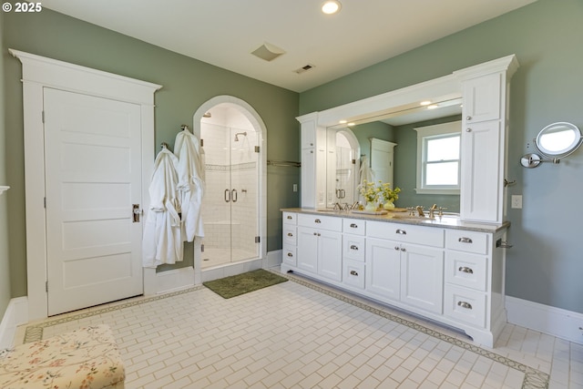 full bathroom with a stall shower, double vanity, recessed lighting, baseboards, and tile patterned floors