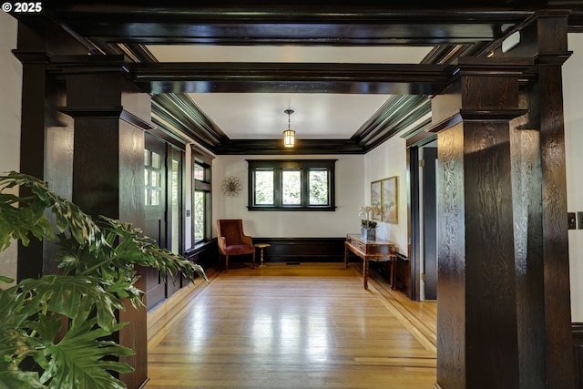 living area featuring hardwood / wood-style floors and crown molding