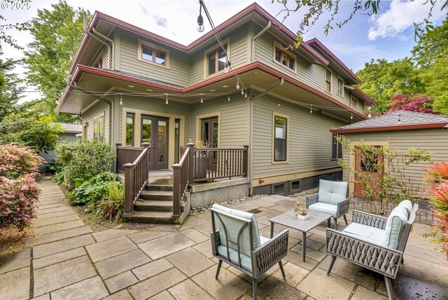 back of house featuring a patio area, french doors, an outdoor living space, and a deck
