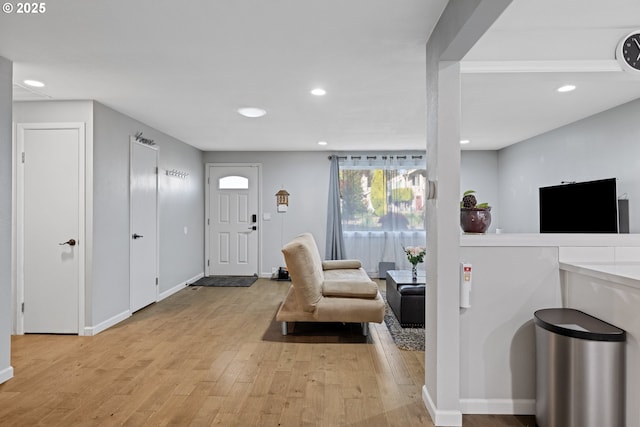 entryway featuring recessed lighting, baseboards, and light wood-style floors