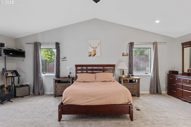 bedroom with baseboards, light colored carpet, and lofted ceiling