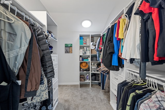 walk in closet featuring light colored carpet