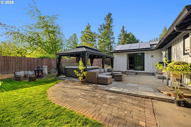 view of patio / terrace with a gazebo, a fenced backyard, a hot tub, and outdoor lounge area