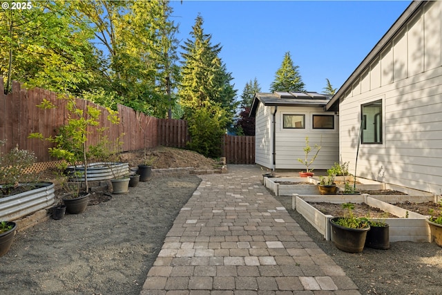 view of patio featuring a garden and a fenced backyard