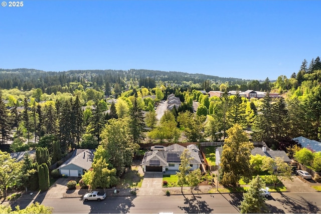 birds eye view of property featuring a view of trees and a residential view