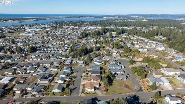 drone / aerial view with a water view and a residential view