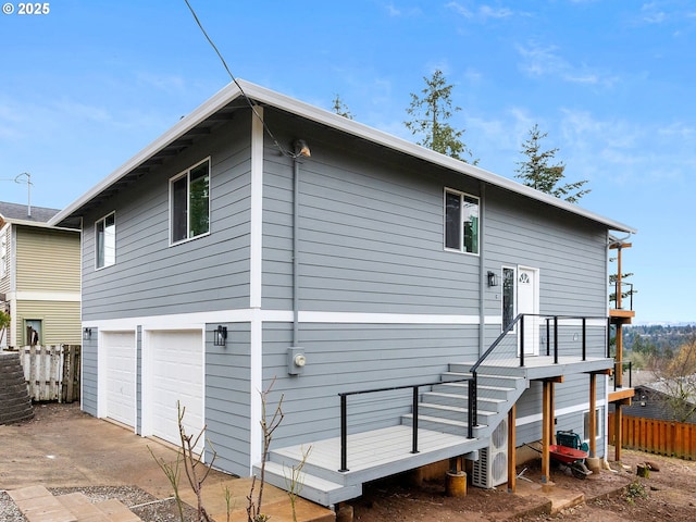 back of property with a garage and fence