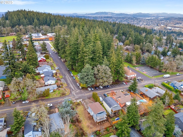 birds eye view of property with a forest view and a mountain view