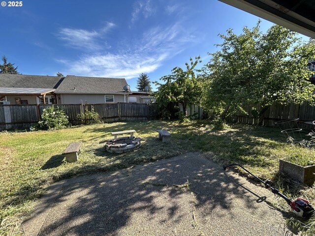 view of yard with an outdoor fire pit