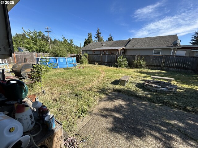 view of yard with an outdoor fire pit
