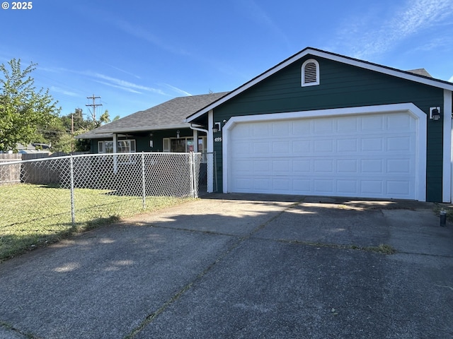 ranch-style home with driveway, an attached garage, and roof with shingles