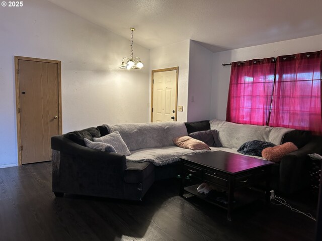 living room with vaulted ceiling, wood finished floors, and a chandelier