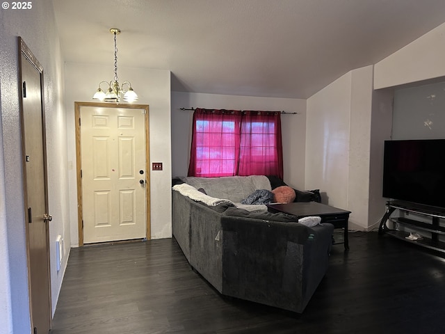 living area with a chandelier and dark wood finished floors