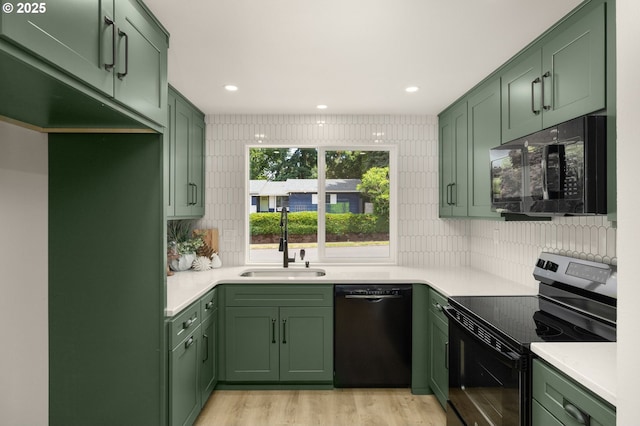 18090 NW Avalon Dr, Portland, OR 97229 - kitchen with green cabinets, black appliances, light countertops, and recessed lighting