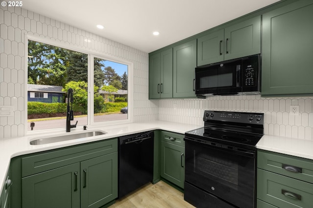 18090 NW Avalon Dr, Portland, OR 97229 - kitchen with black appliances, green cabinets, light countertops, and recessed lighting
