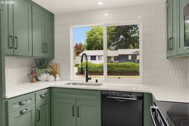 18090 NW Avalon Dr, Portland, OR 97229 - kitchen with green cabinetry, black dishwasher, backsplash, and light countertops