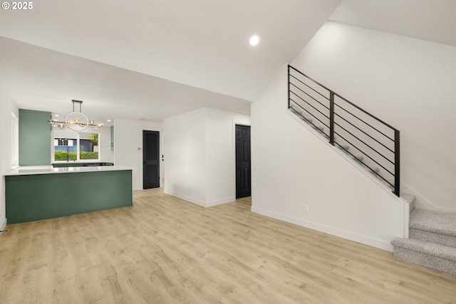 18090 NW Avalon Dr, Portland, OR 97229 - unfurnished living room featuring a chandelier, light wood-type flooring, stairs, and recessed lighting