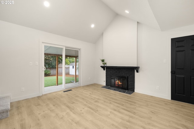 18090 NW Avalon Dr, Portland, OR 97229 - unfurnished living room with high vaulted ceiling, a brick fireplace, recessed lighting, and wood finished floors