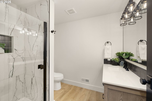 18090 NW Avalon Dr, Portland, OR 97229 - bathroom featuring vanity, a marble finish shower, and wood finished floors