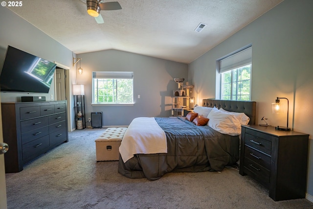 2872 Bluff Ave, Salem, OR 97302 - carpeted bedroom featuring multiple windows, vaulted ceiling, a ceiling fan, a textured ceiling, and baseboards