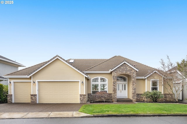 view of front of house with an attached garage, brick siding, a tiled roof, concrete driveway, and a front yard