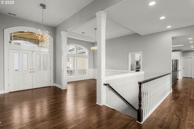 entryway with decorative columns, visible vents, dark wood finished floors, and recessed lighting