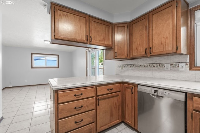 5270 Faircrest Ct SE, Salem, OR 97306 - kitchen featuring a peninsula, light countertops, brown cabinets, dishwasher, and decorative backsplash