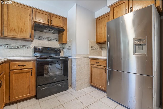 5270 Faircrest Ct SE, Salem, OR 97306 - kitchen with brown cabinetry, light countertops, stainless steel fridge, and black range with electric cooktop
