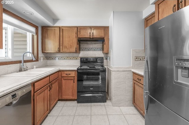 5270 Faircrest Ct SE, Salem, OR 97306 - kitchen with light tile patterned floors, brown cabinets, a sink, light countertops, and appliances with stainless steel finishes