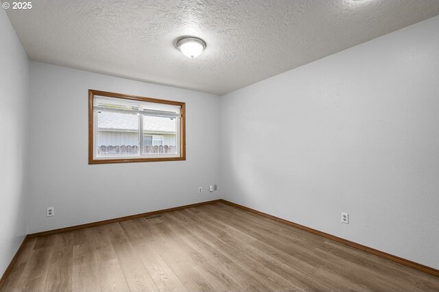 5270 Faircrest Ct SE, Salem, OR 97306 - spare room with a textured ceiling, visible vents, wood finished floors, and baseboards