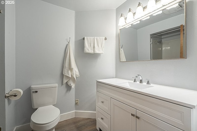 5270 Faircrest Ct SE, Salem, OR 97306 - bathroom featuring vanity, toilet, wood finished floors, and baseboards