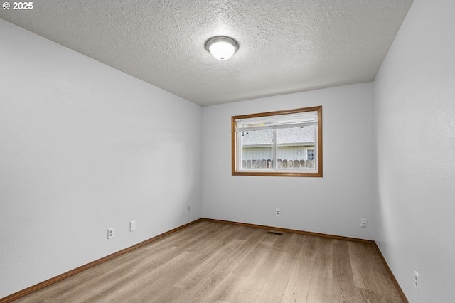 5270 Faircrest Ct SE, Salem, OR 97306 - empty room with a textured ceiling, wood finished floors, and baseboards