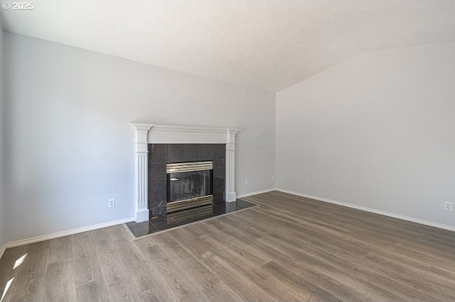 5270 Faircrest Ct SE, Salem, OR 97306 - unfurnished living room featuring a tile fireplace, baseboards, wood finished floors, and lofted ceiling