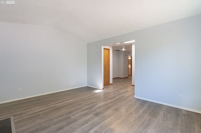 5270 Faircrest Ct SE, Salem, OR 97306 - spare room with vaulted ceiling, baseboards, and wood finished floors