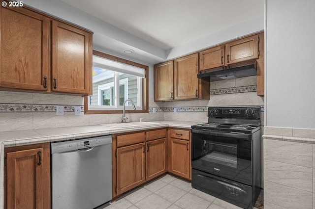 5270 Faircrest Ct SE, Salem, OR 97306 - kitchen with black electric range oven, a sink, brown cabinetry, dishwasher, and under cabinet range hood