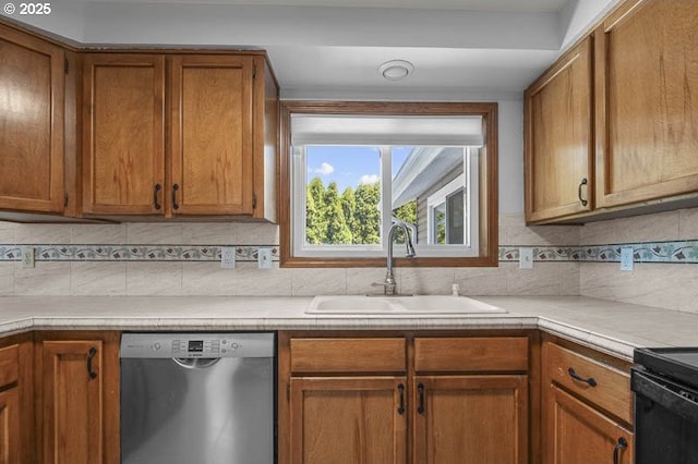 5270 Faircrest Ct SE, Salem, OR 97306 - kitchen featuring brown cabinets, a sink, stainless steel dishwasher, light countertops, and tasteful backsplash
