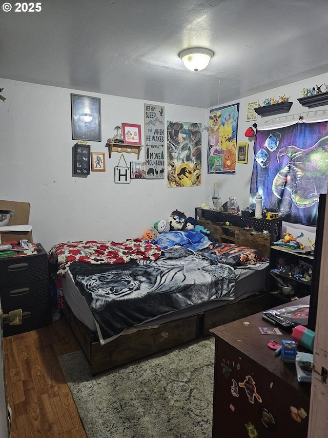 bedroom with dark wood-type flooring and a textured ceiling