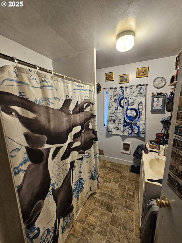 bathroom featuring vanity, a textured ceiling, and a shower with shower curtain