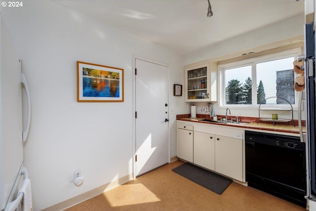 kitchen featuring dishwasher, white fridge, sink, and white cabinets