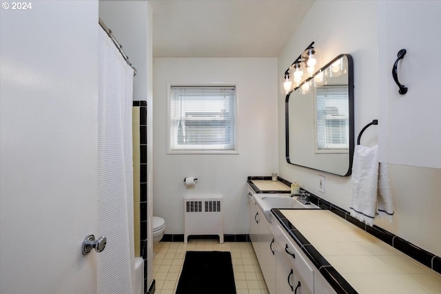 bathroom featuring tile patterned flooring, radiator heating unit, vanity, a shower with curtain, and toilet