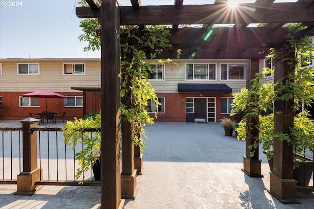 rear view of house with a pergola and a patio area