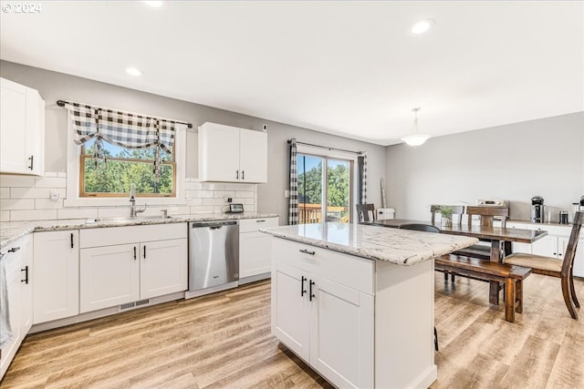 kitchen with white cabinets, dishwasher, sink, and hanging light fixtures