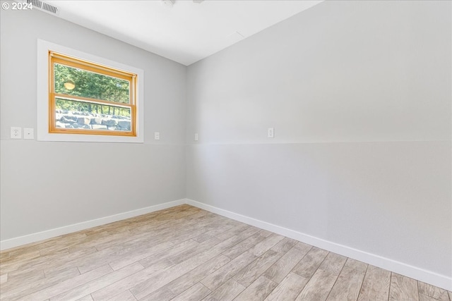 unfurnished room with light wood-type flooring